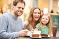 Family Enjoying Snack In Cafe Together Royalty Free Stock Photo