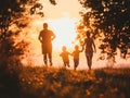 Family Enjoying Sunset Walk in Park Royalty Free Stock Photo