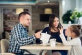 Family Enjoying tea In Cafe Together