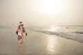 Family enjoying time together on beautiful foggy beach. Royalty Free Stock Photo