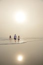 Family enjoying time together on beautiful foggy beach. Royalty Free Stock Photo
