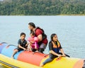 Family enjoying water activities on banana boat at the Kenyir Lake, Terengganu, Malaysia Royalty Free Stock Photo