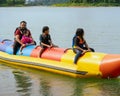 Family enjoying water activities on banana boat at the Kenyir Lake, Terengganu, Malaysia Royalty Free Stock Photo