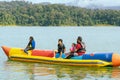 Family enjoying water activities on banana boat at the Kenyir Lake, Terengganu, Malaysia Royalty Free Stock Photo