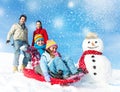 Family Enjoying Winter Day Tobogganing Concept Royalty Free Stock Photo