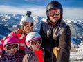 Family enjoying winter vacations taking selfie in skiing gear Royalty Free Stock Photo