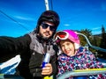 Family enjoying winter vacations taking selfie in skiing gear Royalty Free Stock Photo