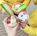 The family enjoys ice cream with fruit and various fillings. Ice cream top view and close up