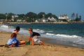 A family enjoys a sunny day on a small stretch of sand