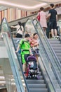 Family on escalator at Livat Shopping Mall, Beijing, China
