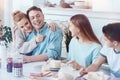 Loving four membered family enjoying their meal at home