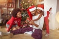 Family exchanging gifts in front of Christmas tree Royalty Free Stock Photo