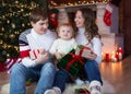 Family exchanging gifts in front of Christmas tree Royalty Free Stock Photo