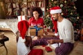 Family exchanging gifts in front of Christmas tree Royalty Free Stock Photo