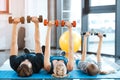 Family exercising with dumbbells at fitness studio