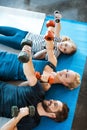 Family exercising with dumbbells at fitness studio Royalty Free Stock Photo