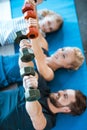 Family exercising with dumbbells at fitness studio Royalty Free Stock Photo