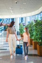 Mother and little girl with nedical masks at airport. Protection against Coronavirus and gripp Royalty Free Stock Photo