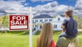 Family Facing For Sale Real Estate Sign and House Royalty Free Stock Photo
