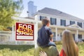 Family Facing Sold For Sale Real Estate Sign and House Royalty Free Stock Photo