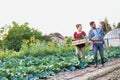 Family of famers carrying their vegetables home in wooden boxes, at the end of the day, the Father is carrying their Royalty Free Stock Photo