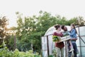 Family of famers carrying their vegetables home in wooden boxes, at the end of the day, the Father is carrying their daughter Royalty Free Stock Photo