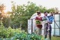 Portrait of a family of famers carrying their vegetables home in wooden boxes, at the end of the day, the Father is carrying their Royalty Free Stock Photo