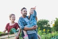 Portrait of a family of famers carrying their vegetables home in wooden boxes, at the end of the day, the Father is carrying their Royalty Free Stock Photo