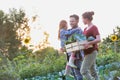Portrait of Family of famers carrying their vegetables home in wooden boxes, at the end of the day, the Father is carrying their d Royalty Free Stock Photo