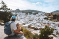 Family father and child traveling in Rhodes island, Greece sightseeing Lindos city