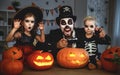 Family father and children in costumes and makeup to halloween w