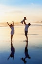 Family - father, mother, baby walk on sunset beach Royalty Free Stock Photo