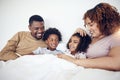 Family, father and mother with children on bed relaxing together for fun morning or holiday break at home. Happy dad Royalty Free Stock Photo