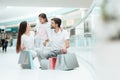 Family, father, mother and daughter are sitting in shopping mall. Royalty Free Stock Photo