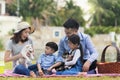 A family with a father, mother and daughter, son on a picnic And play with Shiba Inu puppies Royalty Free Stock Photo