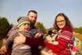 Family with father, mother and son with dog outdoors in an autumn sunny day. Friendship people and dog Royalty Free Stock Photo