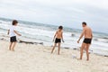 Family father two kids playing football on beach Royalty Free Stock Photo