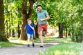 Happy father and son compete in running at park