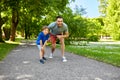 Happy father and son compete in running at park