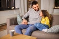 Happy father and little daughter at home at night Royalty Free Stock Photo