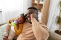 Father with baby at home calling on smartphone Royalty Free Stock Photo