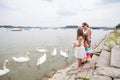 Family Feeding Swans On River Royalty Free Stock Photo