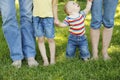 Family feet in jeans on the grass Royalty Free Stock Photo