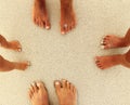 Family feet on the sand on the beach Royalty Free Stock Photo