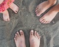 Family feet on the sand on the beach Royalty Free Stock Photo