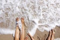 Family feet wet by the sea waves at the beach in summer holiday Royalty Free Stock Photo
