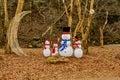 Family of festive snowmen beside crescent moon