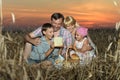 Family in field in sunset