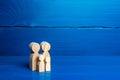 Family figures of parents and kids on a blue background. Family values and health. Adoption and custody of children