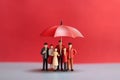 Family figurine under red umbrella, business concept Generative AI